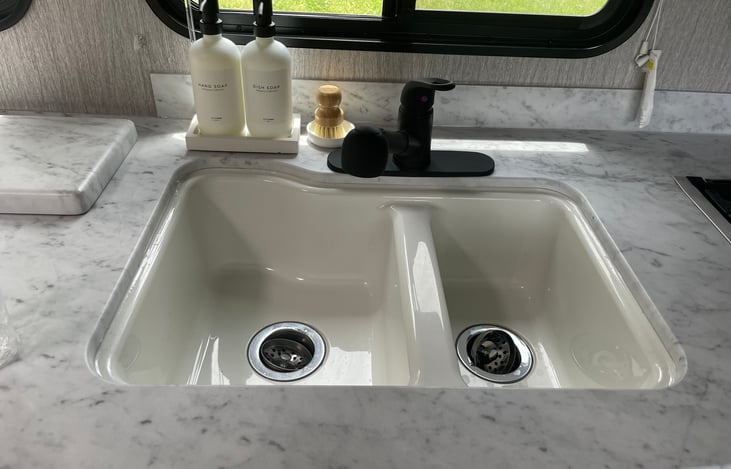 Double sink and wand on faucet for easier dishwashing.