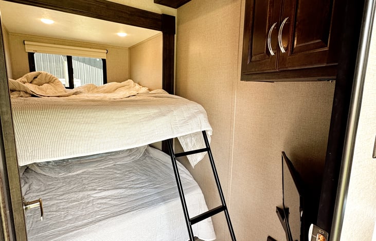 Second bedroom / bunk room has larger double size beds that can accommodate children or adults, as well as upper and lower storage, a TV/DVD player, and comfy 100% cotton Hearth & Hand premium bedding