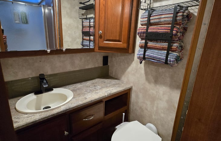 Towels, washcloths, soap, and toilet paper are provided.