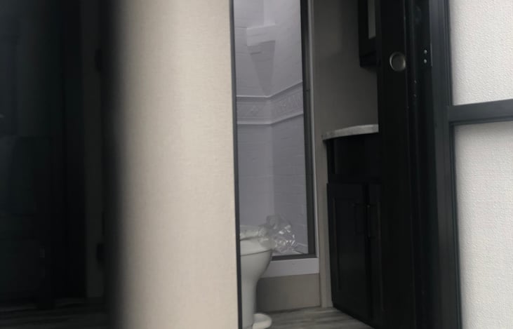 Full bathroom with shower and skylight.