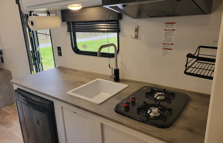 Kitchenette with dorm fridge, 2 burner range and microwave. Cookware and dishware included.