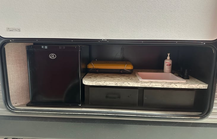 Outdoor sink and refrigerator.