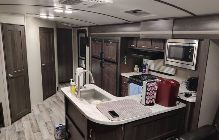 The center island kitchen with double frig makes long stays a breeze. With three burner stove and oven, microwave and airfryer provided adds many cooking options.