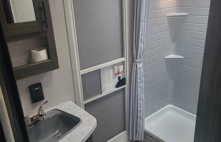 Bathroom with large shower and separate outdoor entry