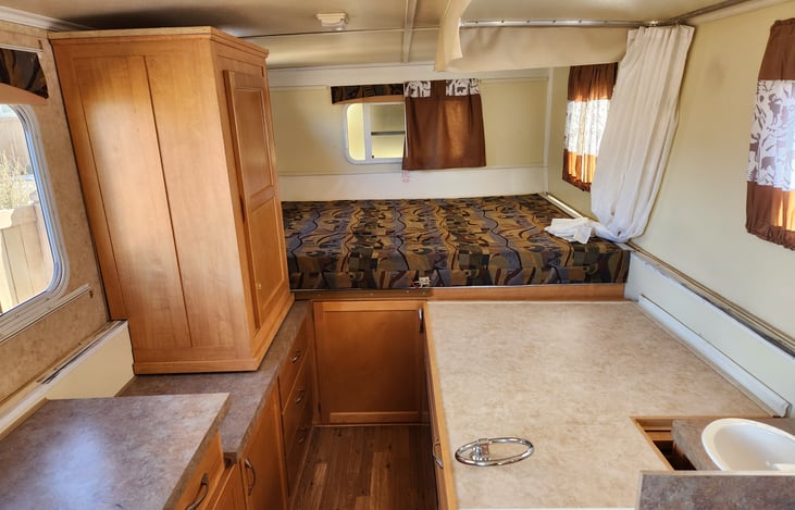 Queen bed with the bathroom walls down.