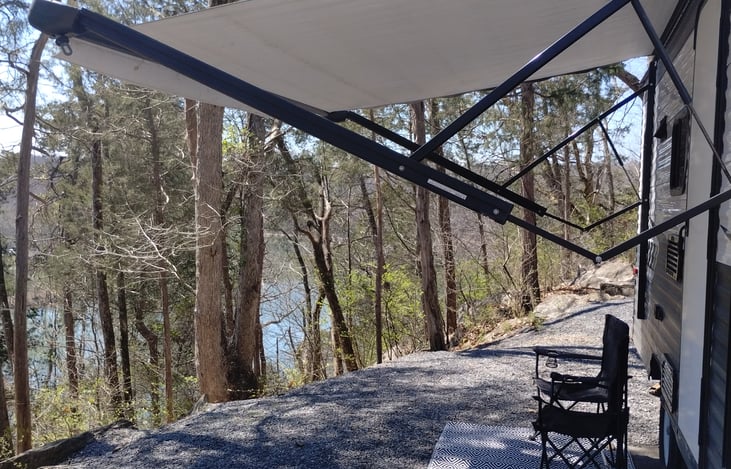 Awning with chairs overlooking lake at Warriors' Path State Park
