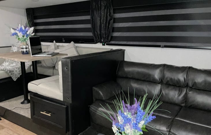 Dinette and living area. Adjustable Zebra shades give complete privacy from the outside view. (Laptop on dinette not included in rental.)