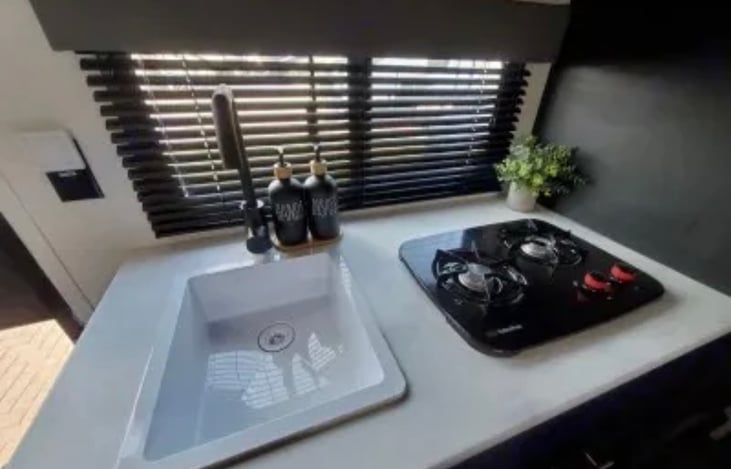 Kitchen sink and two burner stove top.