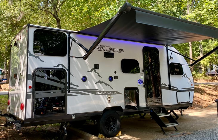 Mini fridge and bunk area storage, accessible from exterior.