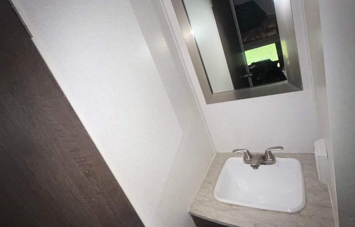 Bathroom sink, cabinet are a