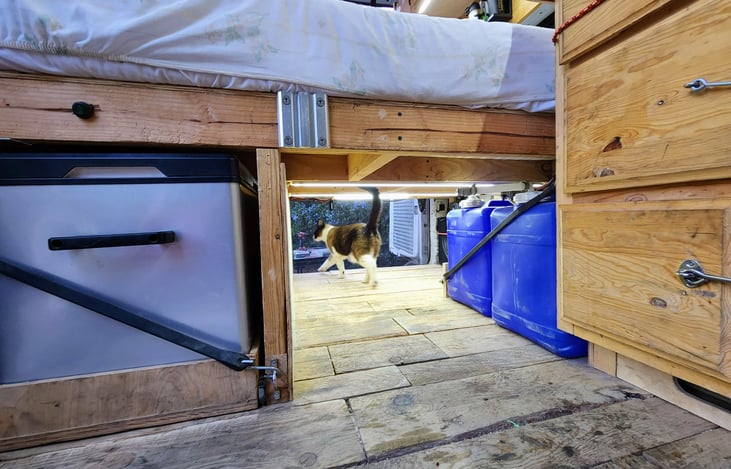 Fresh water tanks and the fridge are stored under the bed