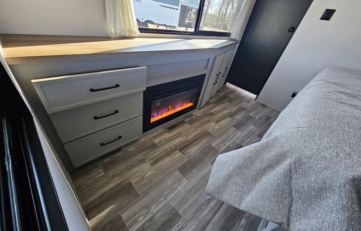Warm electric fireplace in primary bedroom