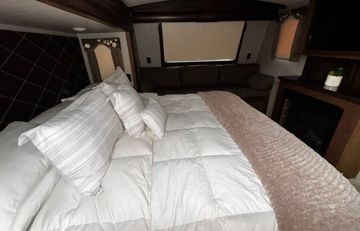 Cozy shades and  tv, and fireplace in the Master bedroom