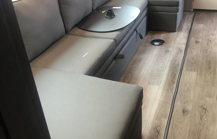 Party sectional seats several with 2 island tables. Center of coach pulls out to a queen memory foam bed.