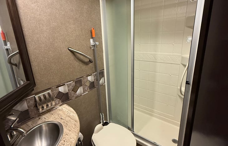 Private bathroom. Standing walk in shower, toilet, and sink.