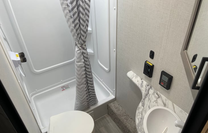 Walk in roomie shower. Hot water supplied from the tankless water heater.