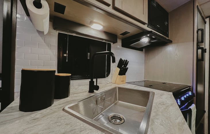 White subway tile backsplash in the fully stocked kitchen. All you need to bring is your food!