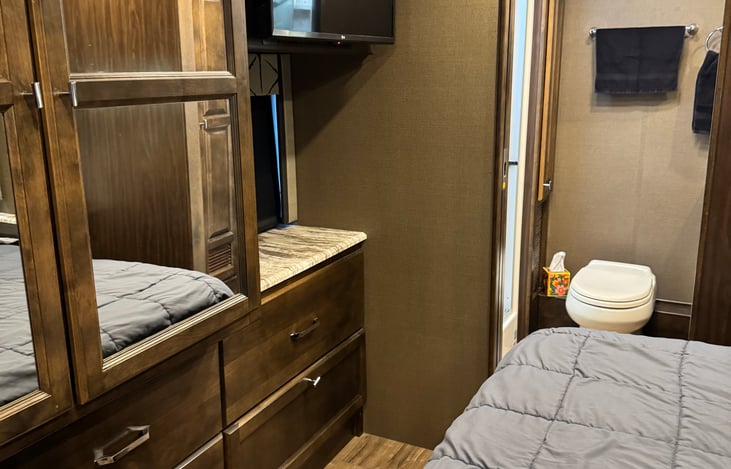 bedroom with view of entrance to full bath