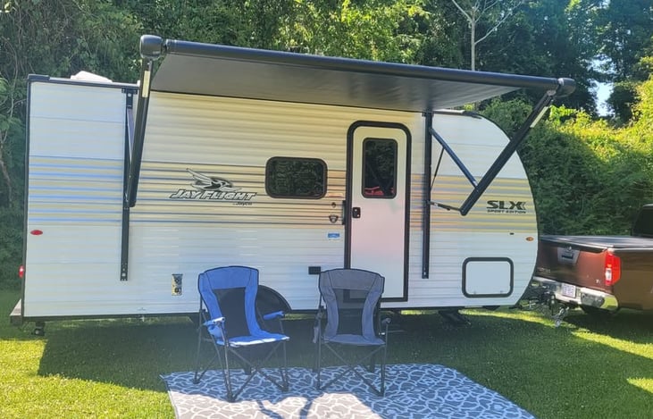 Typical layout with 10 foot power awning extended, 2 full sized camping chairs over a 6 x 9 reversible mat; 2 smaller chairs for kids also supplied. All accessories included