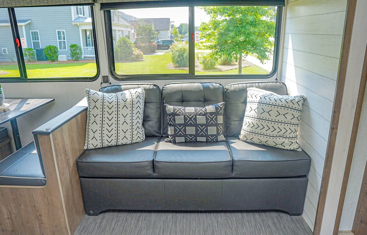 Comfy couch and stylish pillows to host.