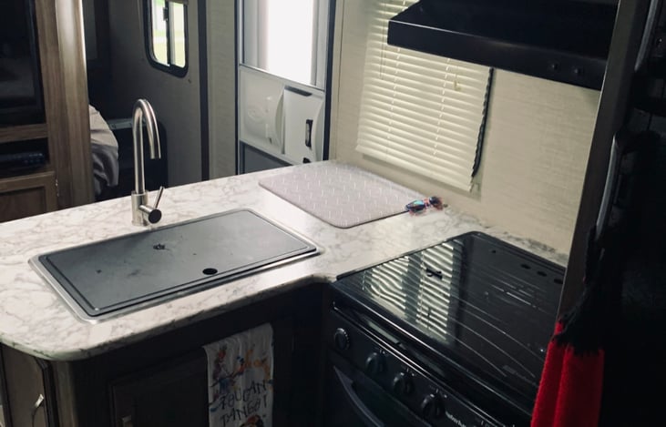 Kitchen area. Sink has a top to create more counter space.