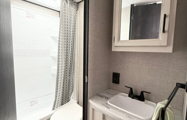 Full bathroom tub and shower with toilet.  Sink jusr outside with mirror for privacy