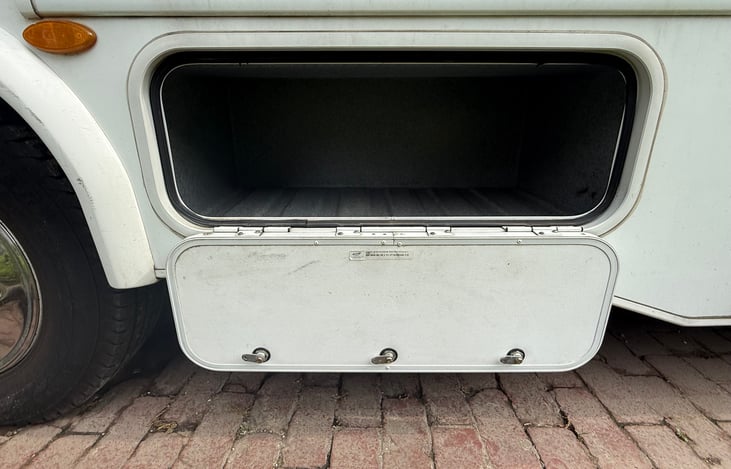 Passenger side compartment #3. We like to put our cases of water in here.