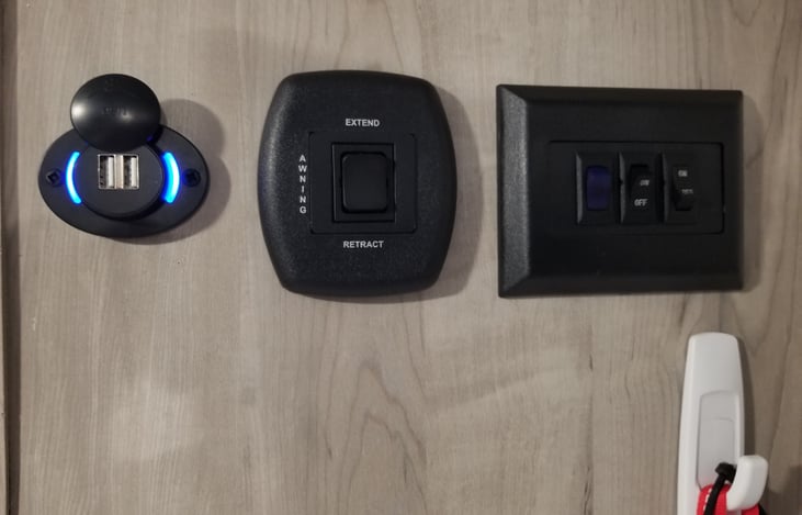 LEFT TO RIGHT*USB PORT, AWNING SWITCH, FRONT OUTSIDE LIGHT, BACK OUTSIDE LIGHT, INSIDE LIGHTS