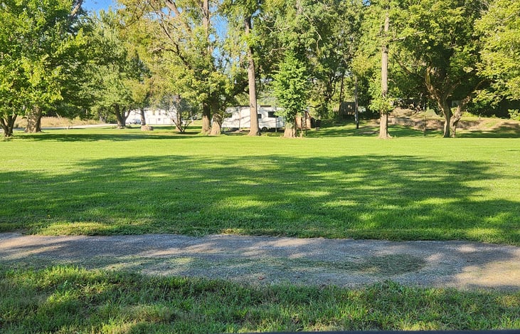 The sidewalk leading to the park.