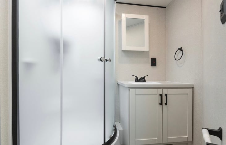 Large bathroom with sink, shower and toilet.