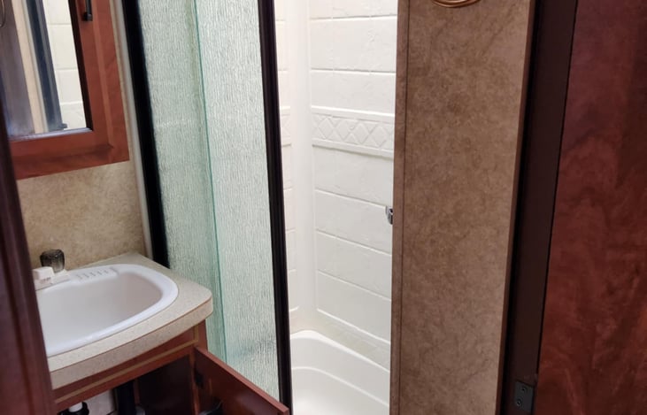 We have removed the glass shower door and replaced it with a curtain.