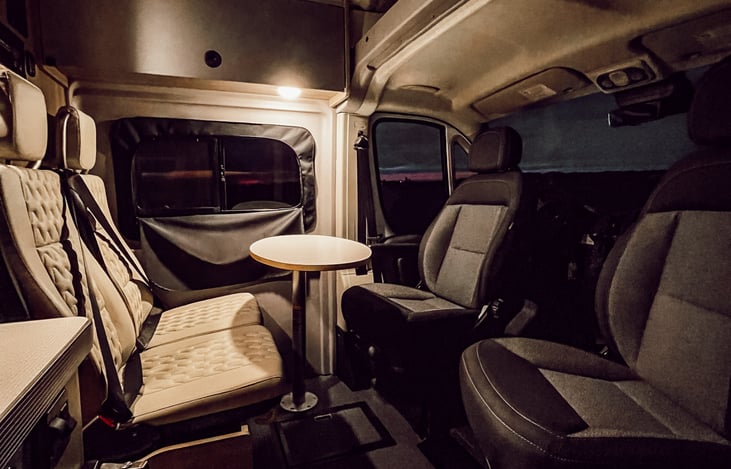 Removable table safely secures behind two passenger seats.