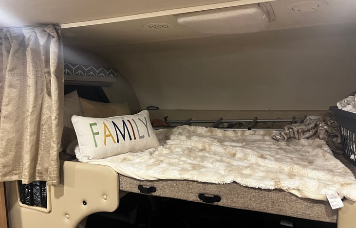 Overhead bunk sleeps two adults.