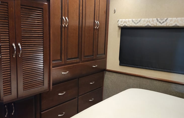 Bedroom in rear with washer/dryer combo behind the left move set of doors.