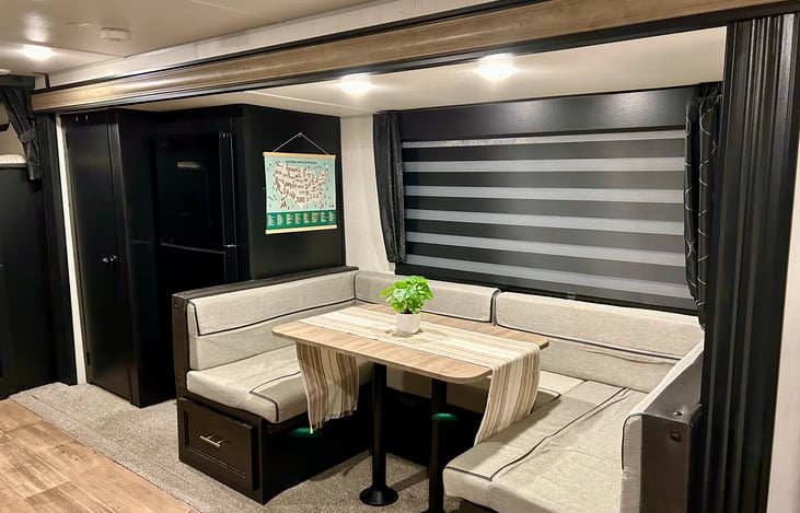 Dinning area, that also converts to a full size bed. Large fridge and pantry area with door.