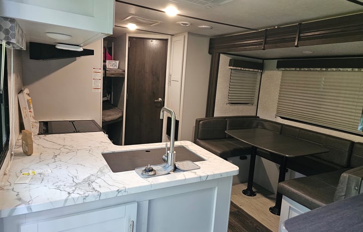 Dinette U-shaped slide with storage under seats.