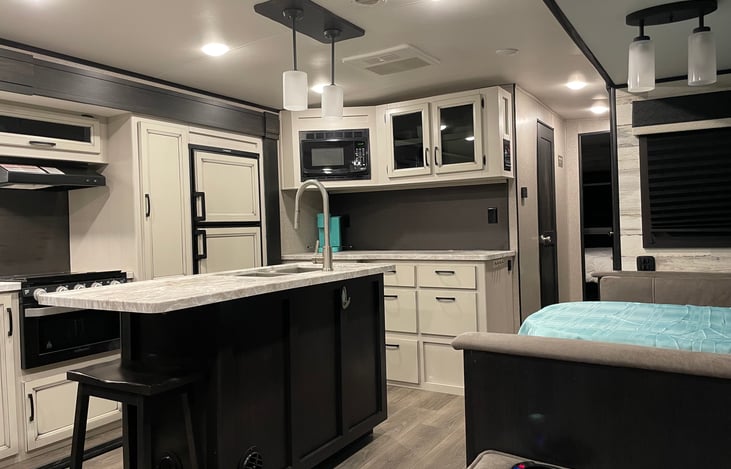 Kitchen showing Kuerig and counter space with dinette and island