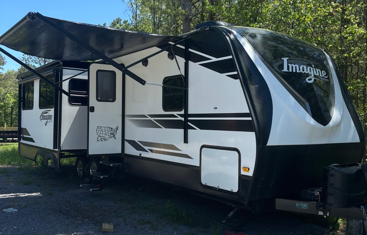 Features two awnings, one over the door and the other over the slide.