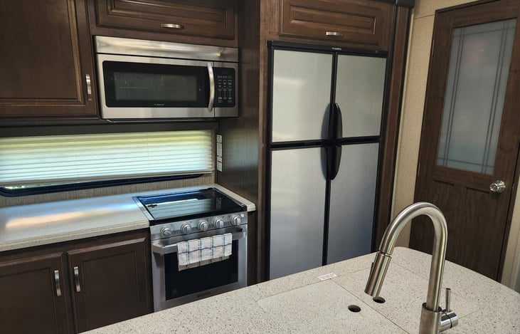 Kitchen w/ double refrigerator/ freezer/ large pantry