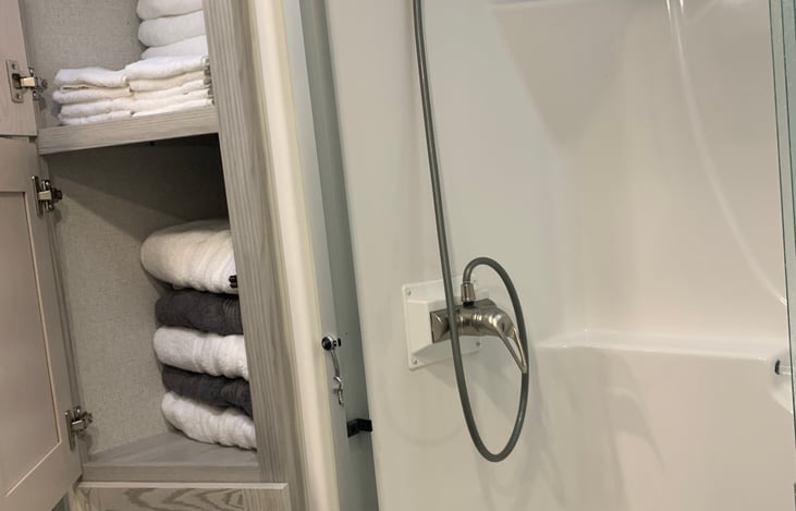 Large shower and stocked linens.