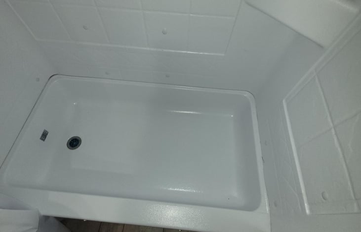 Small bathtub in bottom of shower