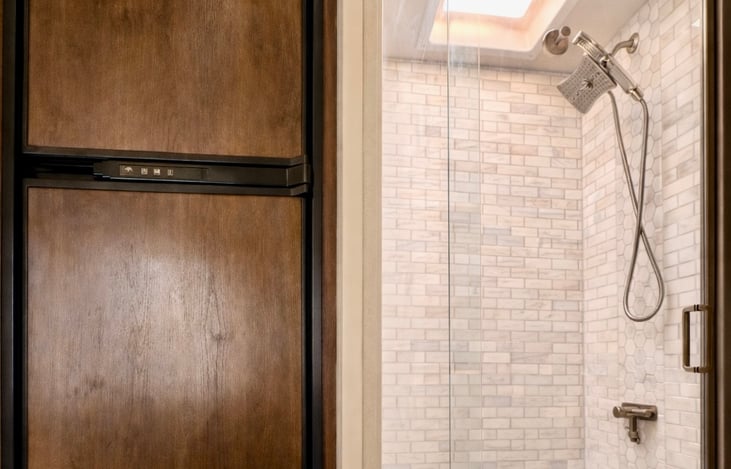 Fridge and updated tiled shower with regular shower head