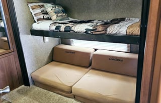 Large RV with outdoor kitchen, fireplace, and TVs