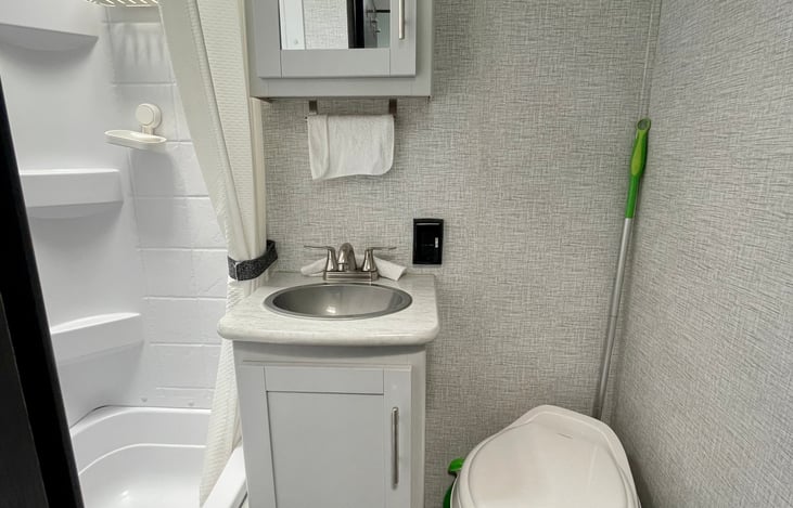 Foot flush toilet, sink with cold and hot water