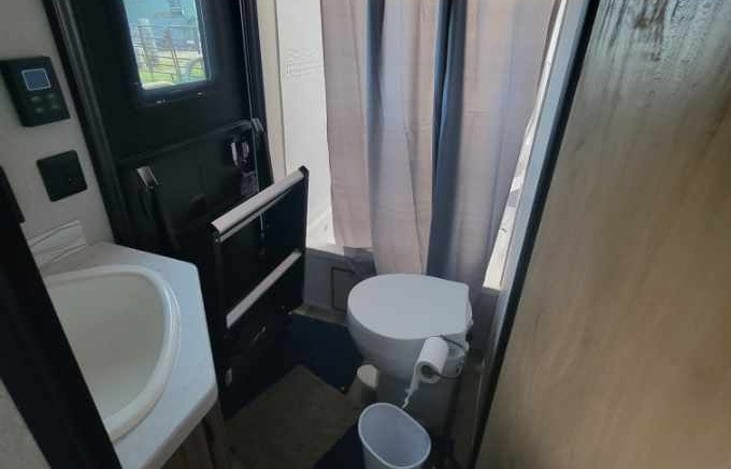 Convenient outside entrance directly to bathroom.
Bathroom is located opposite end of the camper/private bedroom with queen bed.