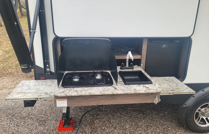Outdoor Kitchen! Stovetop, refrigerator, and sink. Gas hookup available for grill, griddle, or other propane powered item
