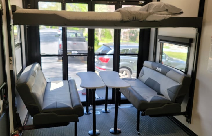 Bright and open rear dining area. The bed above can be moved into a higher position.