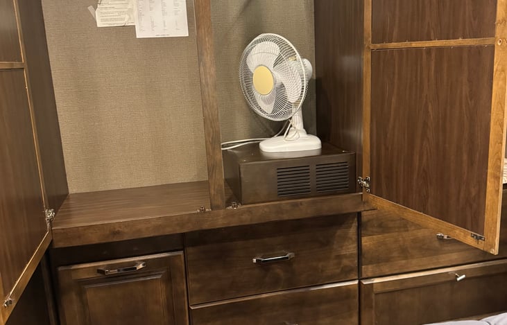 large closet in bedroom includes hangers; mirrors on outside of each door; laundry bin under closet on the left, along with 3 large drawers. Extra fan if needed.