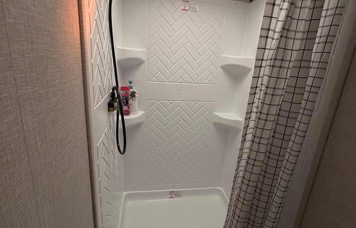Enjoy the large shower with high ceiling.