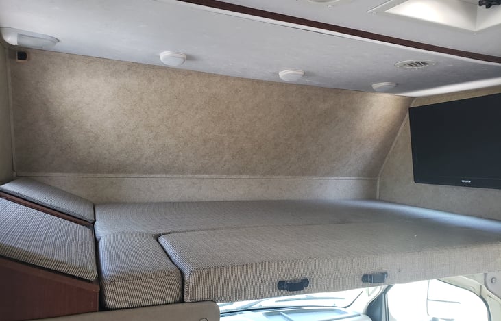 The cab-over bed is an oversized Queen with the large Flat Screen on a swivel arm.